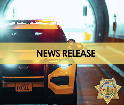 A yellow San Mateo County Sheriff's Office patrol vehicle with lights activated, parked in a tunnel, overlaid with a "News Release" banner and the Sheriff's Office badge.