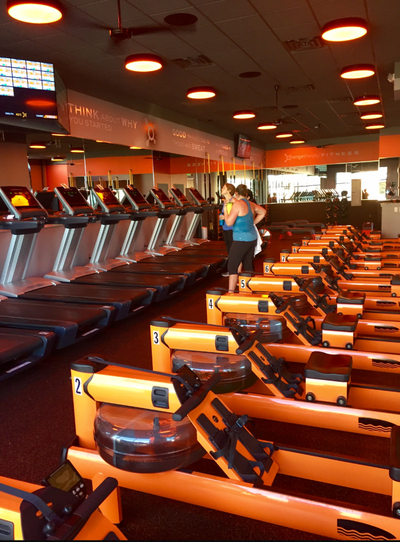 The interior of an Orangetheory Fitness studio, shown in a file photo, features rowing machines and treadmills.