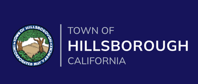 Official Town of Hillsborough, California logo, featuring a circular seal with an illustrated hillside and oak trees beside the text 'Town of Hillsborough, California' in white and gray on a navy background.